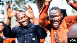 Young people dance on the grounds of the ruling PPRD party campaign office. (C. Oduah/VOA)