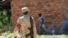 File - A soldier walks through a market in Central Equatoria state, Dec. 23, 2020, ten years after South Sudan gained its independence and two years after its own deadly civil war ended - the use of rape as a weapon remains rampant.