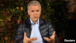 Colombian presidential candidate of the Democratic Center party Ivan Duque gestures during an interview with Reuters in Bogota, Colombia, June 11, 2018.