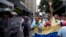 Opposition leader Leocenis Garcia, right, with members of his party, shout slogans against Venezuela's President Nicolas Maduro outside the attorney general's office, where police stand guard, in Caracas, Venezuela, July 18, 2018. The previous night, another opposition leader, Henrique Capriles, called on the country's political forces to reorganize in order to cope with the South American country's hyperinflation, and lack of food and medicine.