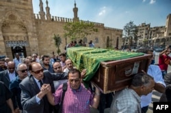 Ashraf Zaki (2nd-L), head of the Egyptian actors syndicate, along with veteran Egyptian actor Ezzat al-Alayli (3rd-L), walk with relatives and friends carrying the coffin of French Egyptian veteran actor Gamil Ratib during his funeral as they exit Al-Azhar mosque in the Islamic quarter of the capital Cairo, on September 19, 2018.