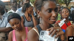 After receiving their voter ID cards, local residents wait in line to claim their newly-issued national identity cards in the Plateau neighborhood of Abidjan, Ivory Coast, 7 Oct 2010
