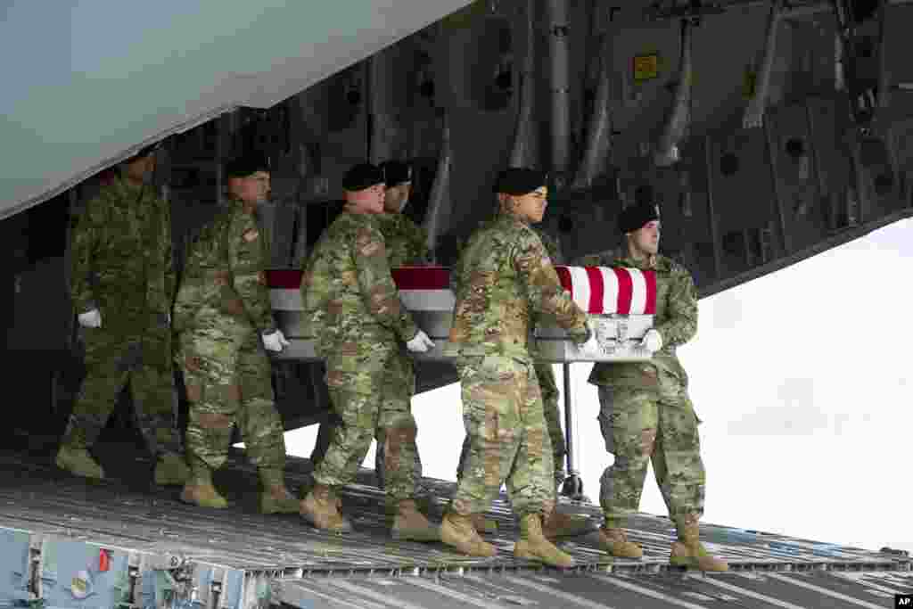 An Army carry team brings homes the remains of Army Sgt. Douglas Riney, 26, of Fairview, Ilinois, at Dover Air Force Base, Delaware. Riney died of wounds received fighting in Afghanistan.