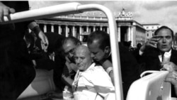 FILE - Pope John Paul II lies bleeding in his open car moments after he was shot by Turkish gunman Mehmet Ali Agca in 1981.