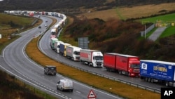 Trucks queue in Dover, England, Dec. 11, 2020. The U.K. left the EU on Jan. 31, but remains within the bloc's tariff-free single market and customs union until the end of the year. 
