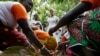 FILE - Ivanka Trump, center, watches as women demonstrate how they process cocoa at Cayat, a cocoa and coffee cooperative, April 17, 2019, in Adzope, Ivory Coast.