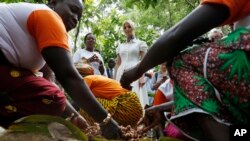 FILE - Ivanka Trump, center, watches as women demonstrate how they process cocoa at Cayat, a cocoa and coffee cooperative, April 17, 2019, in Adzope, Ivory Coast.