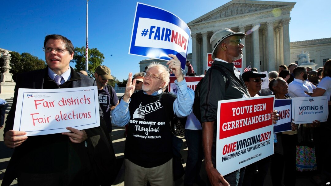 Protesters join others in a rally for fair elections, outside the U.S. Supreme Court in Washington, Oct. 3, 2017.
