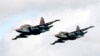 FILE - Russian Sukhoi Su-25 fighter jets are seen during a military exercise near the town of Osipovichi, some 100 km (62 miles) southeast of Minsk, Sept. 2013. Military groups from Armenia, Belarus, Kazakhstan, Kyrgyzstan, Russia and Tajikistan took part in joint military exercises.