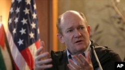 FILE - U.S. Senator Chris Coons, speaks during a press conference with Senator Lindsey Graham, in Amman, Jordan, Feb. 20, 2018.