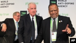 Newly-appointed World Anti-Doping Agency (WADA) president Craig Reedie, center, with his vice-president Makhenkesi Stofile, right, and the outgoing president John Fahey, in Johannesburg, Nov. 15, 2013.