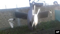 Part of a damaged helicopter is seen lying near the compound after U.S. Navy SEAL commandos killed al-Qaida leader Osama bin Laden in Abbottabad, Pakistan, May 2, 2011.