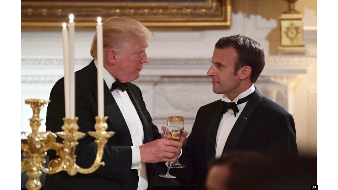 President Donald Trump, left, and French President Emmanuel Macron, right, share a toast during the State Dinner at the White House, April 24, 2018.