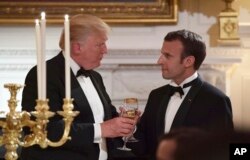 President Donald Trump, left, and French President Emmanuel Macron, right, share a toast during the State Dinner at the White House, April 24, 2018.