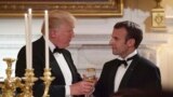 President Donald Trump, left, and French President Emmanuel Macron, right, share a toast during the State Dinner at the White House, April 24, 2018. 