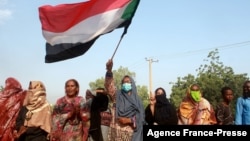 Sudanese protest against a military coup that overthrew the transition to civilian rule, on Oct. 25, 2021 in the al-Shajara district in southern Khartoum.