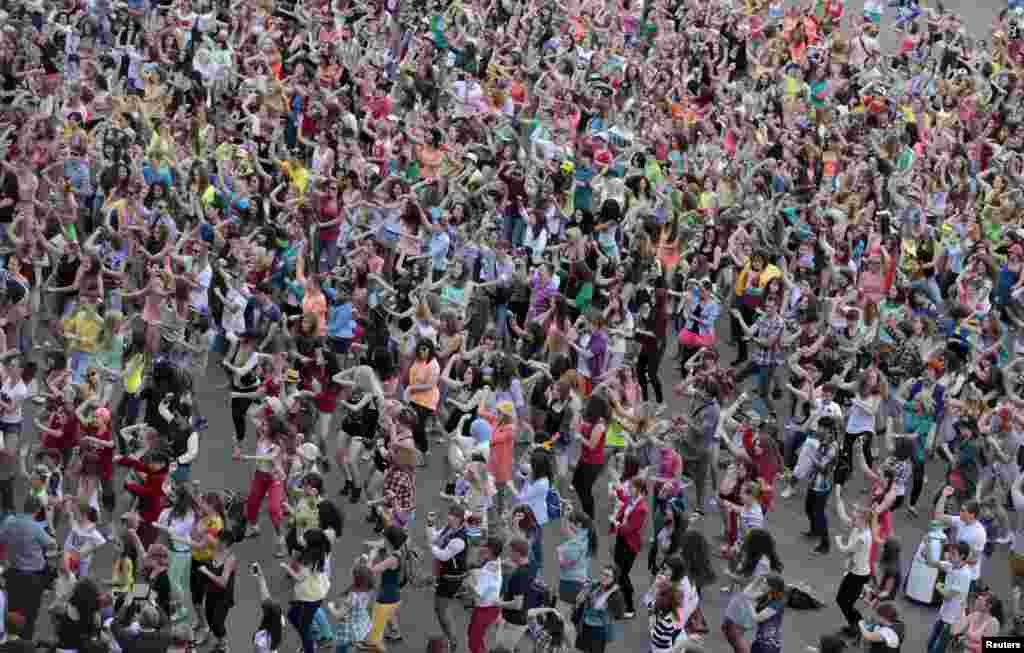 People perform a Gangnam style dance during a flash mob before the arrival of South Korean rapper Psy at the Olympiyskiy (Olympic) sports and entertainment complex in Moscow, Russia. 