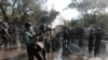 Bangladeshi policemen fire tear gas shells to disperse protestors demanding cancellation of a plan for a massive coal-fired power plant near ecologically sensitive mangrove forests on the coast in Dhaka, Bangladesh, Jan. 26, 2017.