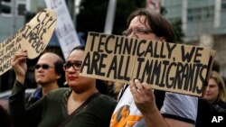 FILE - Tech workers hold signs as they protest Trump administration policies in San Francisco, California, Feb. 13, 2017.