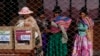 Aymara women wait in line to cast their ballots during judicial elections, in Jesus de Machaca, Bolivia, Dec. 15, 2024.