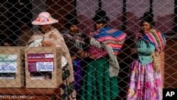 Aymara women wait in line to cast their ballots during judicial elections, in Jesus de Machaca, Bolivia, Dec. 15, 2024.