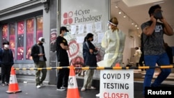 FILE - People queue at a walk-in coronavirus disease testing site in Melbourne, Australia Jan. 5, 2022. 