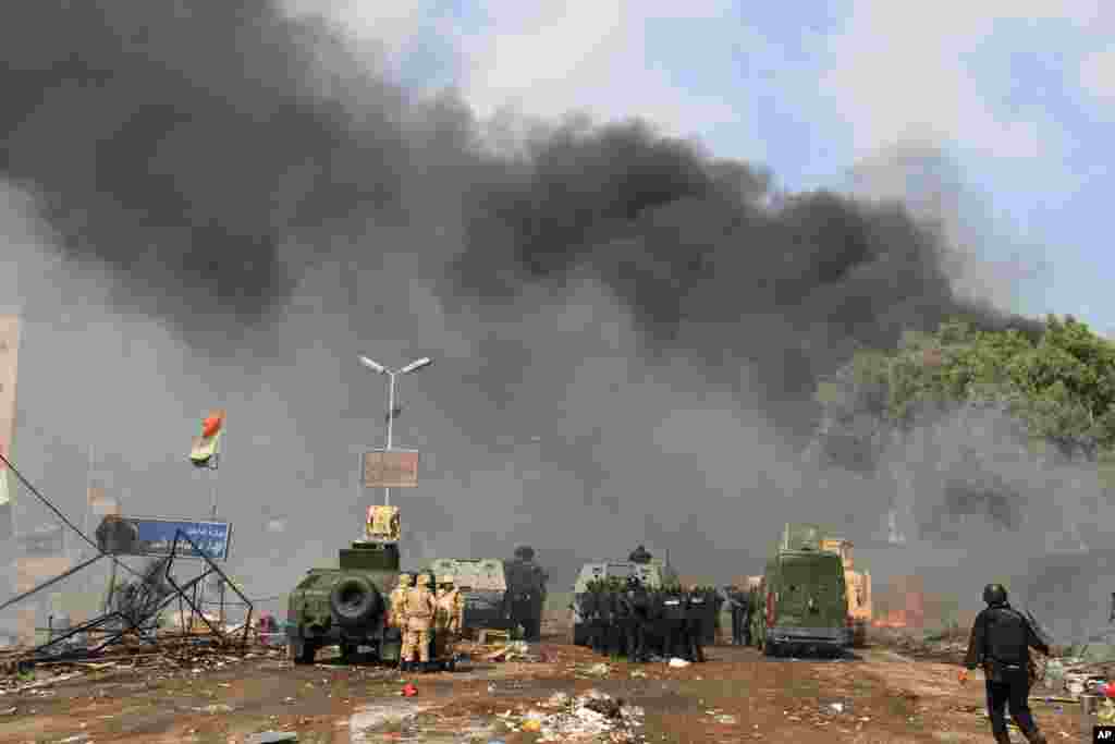 Egyptian security forces inspect the sit-in camp set up by supporters of ousted President Mohamed Morsi in Nasr City district, Cairo, Egypt, Aug. 14, 2013. 