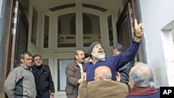 An anti-government protester chants slogans in front of the foreign media in Homs, Syria, January 23, 2012.