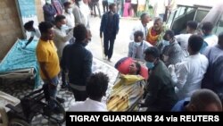 FILE - A woman is taken to Ayder Referral Hospital, in Mekelle, after an airstrike in Togoga, Ethiopia's Tigray region, June 22, 2021.