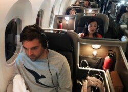 Passengers are seen on board Qantas flight QF7879, flying direct from London to Sydney, Nov. 14, 2019. They took part in experiments to improve the experience of a long flight.