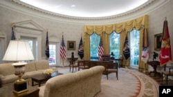 FILE - The newly refreshed Oval Office of the White House is seen in Washington, Aug. 22, 2017, during a media tour. New wallpaper was hung and the floors were refinished this month as part of a series of updates to the West Wing.