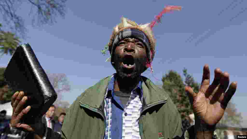 Daniel Sello Mamogodi, a war veteran, chants slogans in support of ailing former South African President Mandela.