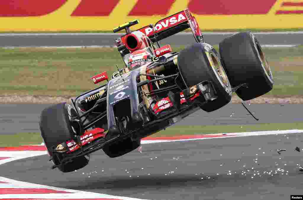 Lotus F1 team driver Pastor Maldonado goes off the track after colliding with Sauber driver Esteban Guitiererrez during the British Grand Prix at the Silverstone Race Circuit, central England.