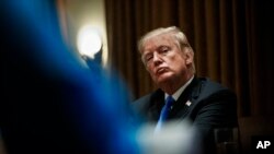 President Donald Trump pauses during a meeting in the Cabinet Room of the White House, in Washington, Feb. 28, 2018, with members of Congress to discuss school and community safety. 