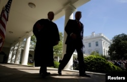 U.S. President Donald Trump walks with Justice Anthony Kennedy after Judge Neil Gorsuch was sworn in as an Associate Supreme Court Justice in the Rose Garden of the White House in Washington, April 10, 2017.