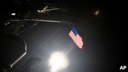 The guided-missile destroyer USS Porter launches a tomahawk land attack missile from the Mediterranean Sea, April 7, 2017.