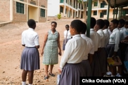 Josephine Kobusingye, an education activist, mentors a group of female science students. She says supporting them is crucial because many of them are facing dificult family situations.