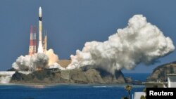 An H-2A rocket carrying an intelligence-gathering satellite successfully takes off from the Tanegashima Space Center in Kagoshima Prefecture, Japan in this photo taken by Kyodo February 27, 2018. 