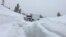 A big rig lacking tire chains slid into a snowbank blocking State Route 88 in Amador County near Tragedy Springs, Calif., Feb. 14, 2019. The snow was so deep in some areas, plows couldn't go out.