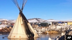 An abandoned teepee is surrounded by melted snow at the Dakota Access oil pipeline protest camp in southern North Dakota near Cannon Ball, Feb. 16, 2017.