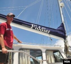 James Hilliard, anggota termuda dari generasi Hilliard yang berpartisipasi dalam "Sail Sabang Regatta" berpose dengan kapal layar Fiddler.