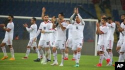Iran's players acknowledge their supporters following a friendly soccer match between Turkey and Iran, in Istanbul, May 28, 2018. The world's largest footwear maker, Nike, says it cannot provide shoes for the Iranian team because of the Trump administration's plan to re-impose U.S. sanctions on Iran.