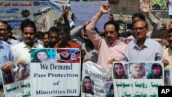 Activists call for protection of Hindu girls at a protest in Hyderabad, Pakistan, March 26, 2019. A court in Islamabad has ordered protection for two sisters from the minority Hindu community as investigators work to determine whether the two were abducted and forced to convert.