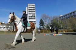 Manuela Jimenez, 15, rides Splash in a riding lesson at Ebony Horse Club in Brixton, London, April 18, 2021. (AP Photo/Kirsty Wigglesworth)