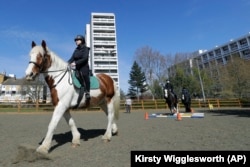 Manuela Jimenez, 15, rides Splash in a riding lesson at Ebony Horse Club in Brixton, London, April 18, 2021. (AP Photo/Kirsty Wigglesworth)