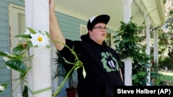 Gavin Grimm leans on a post on his front porch during an interview at his home in Gloucester, Va. Grimm is a transgender student whose demand to use the boys' restrooms has divided the community and prompted a lawsuit. (Steve Helber/AP)