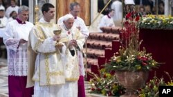 Pope Benedict XVI prepares to offer the communion as he celebrates a mass in St. Peter's Basilica at the Vatican, January 1, 2013.