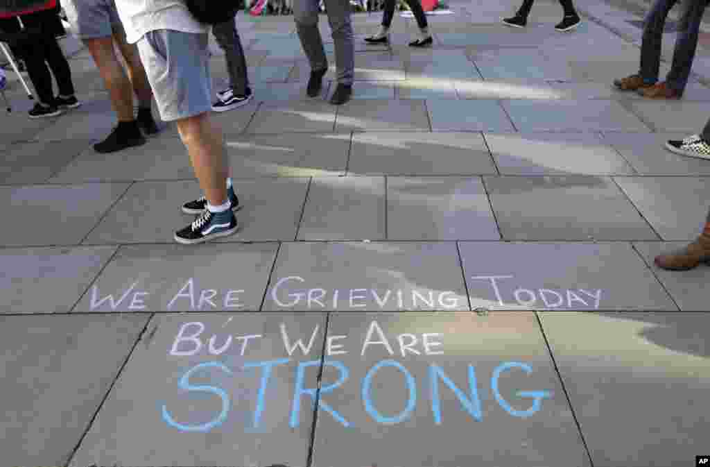 A message is written on the pavement in Manchester, England, May 23, 2017, the day after the suicide attack at an Ariana Grande concert that left 22 people dead.