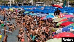 People cool off at the beach during the heatwave in the southeastern coastal town of Benidorm, Spain, August 2, 2018. 