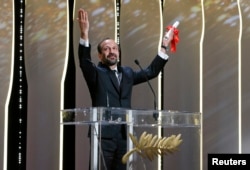 Director Asghar Farhadi, Best screenplay award winner for his film "Forushande" (The Salesman), reacts on stage during the closing ceremony of the 69th Cannes Film Festival in Cannes, France, May 22, 2016.